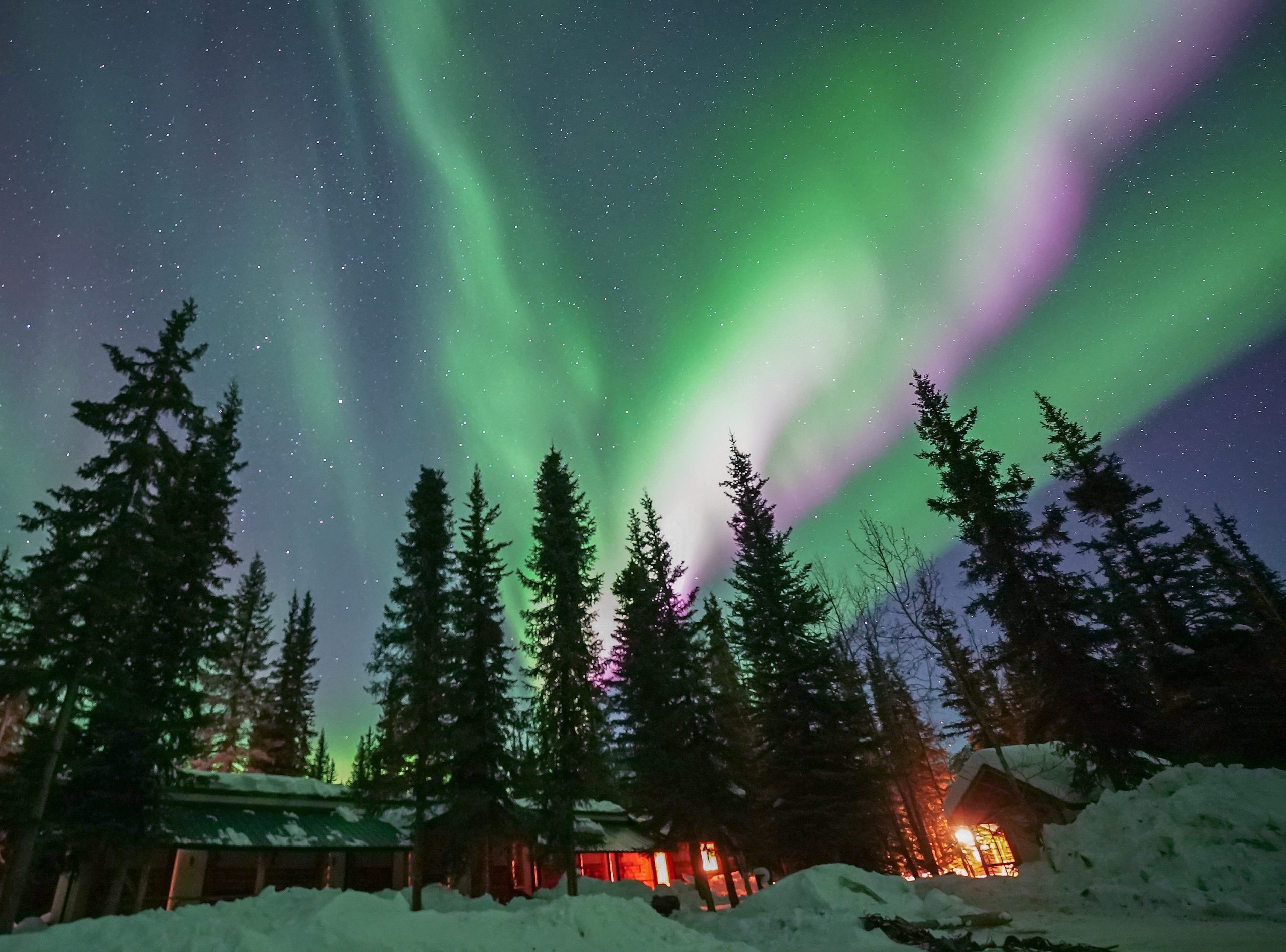 The northern lights dance above the Boreal Lodge in Wiseman in the spring.